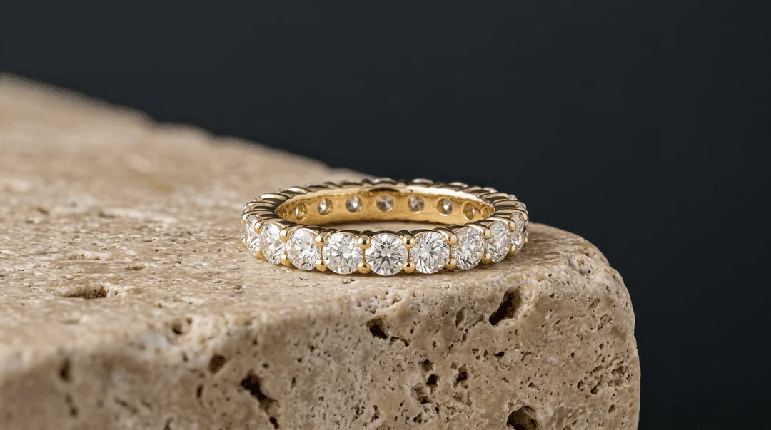 Focus stacked macro photo of gold diamond eternity band on travertine